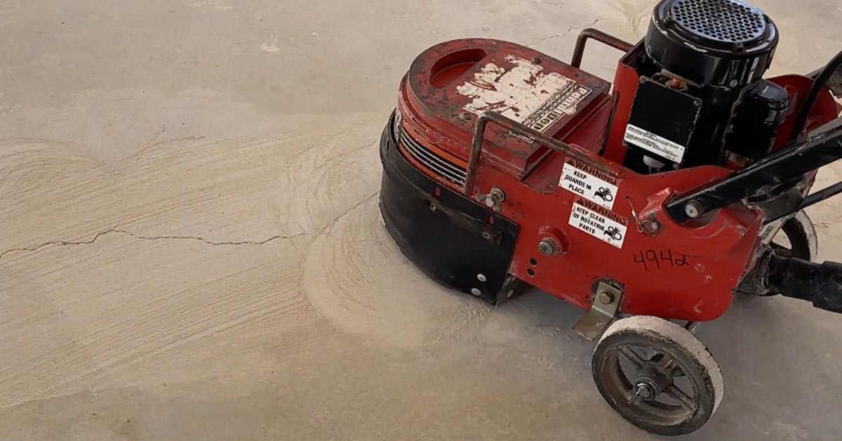 A grinding machine levels a concrete slab.