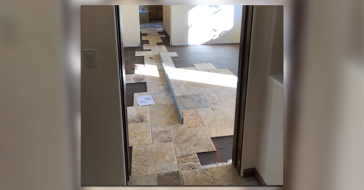 The Versailles pattern of the travertine tile extends through two doorways.