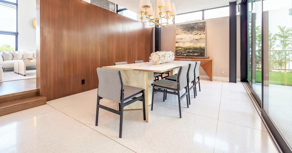 Brightly lit dining room with a terrazzo tile floor.