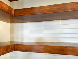 Floating shelf in kitchen with rectangular tile wall