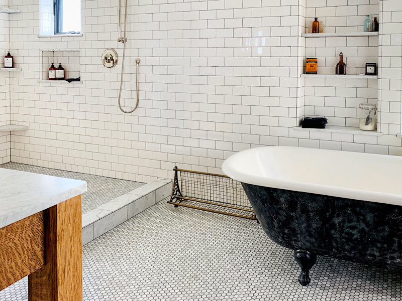 Large bathroom with white subway tile on the walls and small hexagon floor tiles