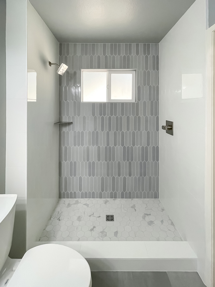 Walk in Shower with Picket Shaped Wall Tile and Hexagon Tile Floor