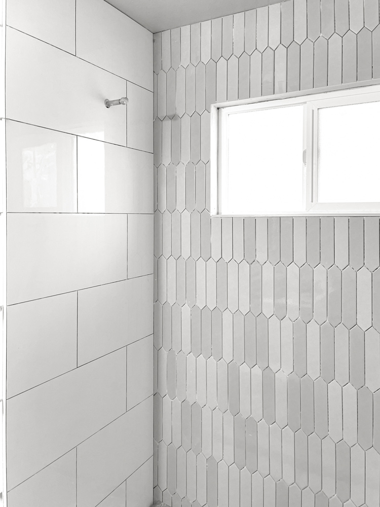 Custom shower with picket shaped multishade grey tiles