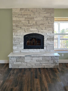 Floor to ceiling stone Fireplace makes a focal point