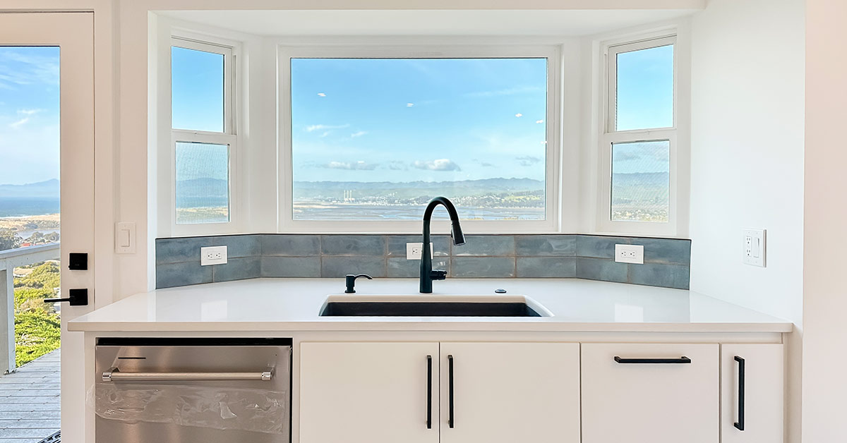 The color of the backsplash compliments the inviting ocean view.